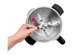 Hand turning the blade of a food processor bowl with a red arrow indicating direction.