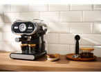 SILVERCREST® Espresso Machine brewing coffee on a wooden counter.