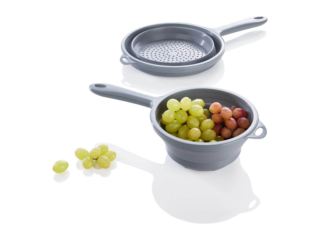 Grey silicone colander and strainer set with grapes.