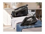 SilverCrest steam generator iron and iron on an ironing board with clothes.