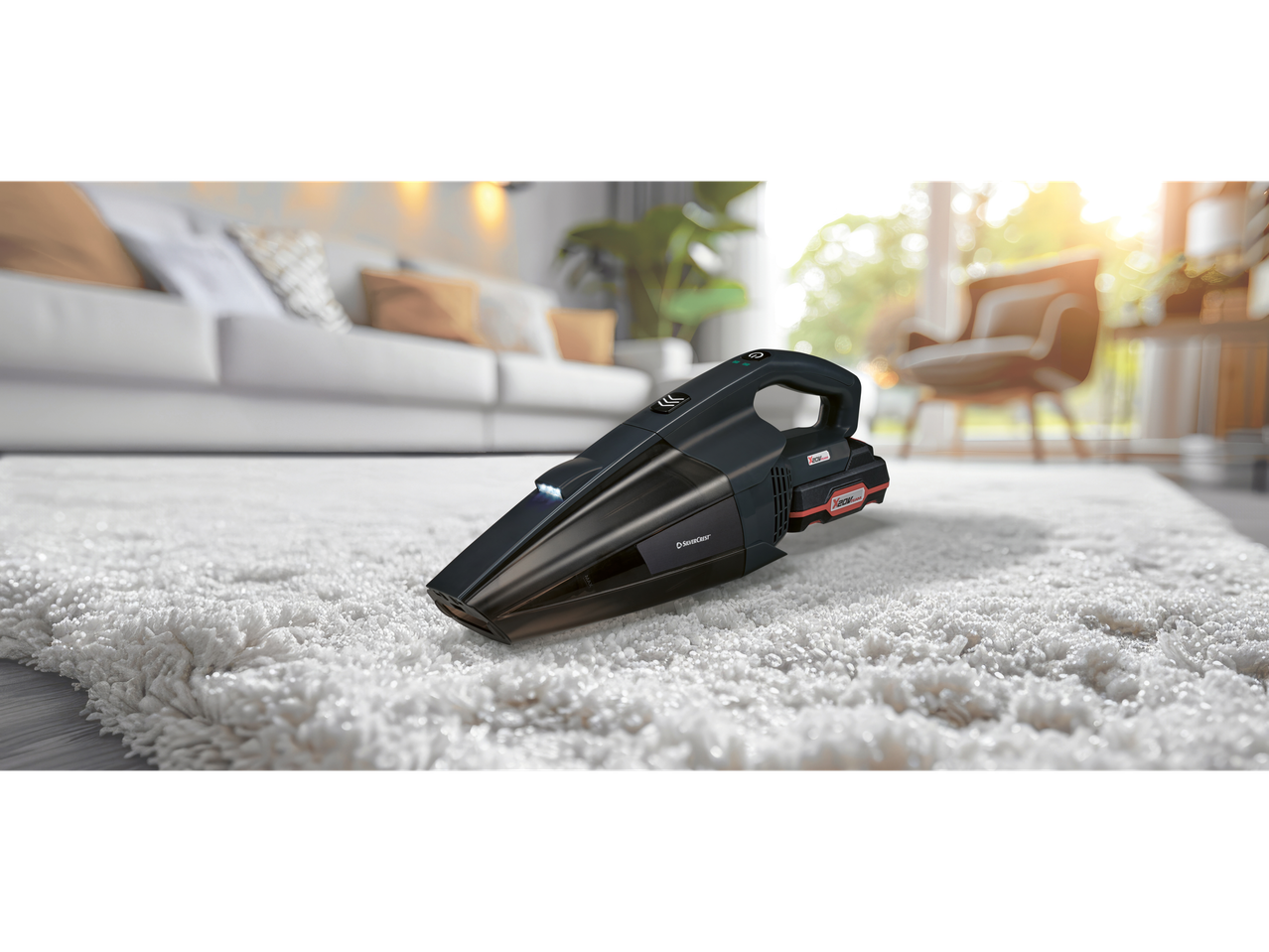 SilverCrest cordless vacuum cleaner on a white rug in a living room.
