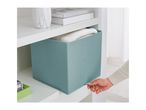 A hand pulling out a teal fabric storage box from a white shelf.