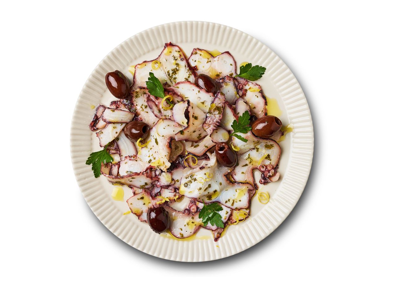Octopus carpaccio with olives, parsley, and lemon zest, drizzled with olive oil on a white plate.