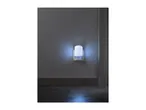 A white night light plugged into a wall outlet, emitting a soft blue glow.