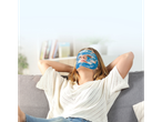 Woman relaxing on couch with a face mask.