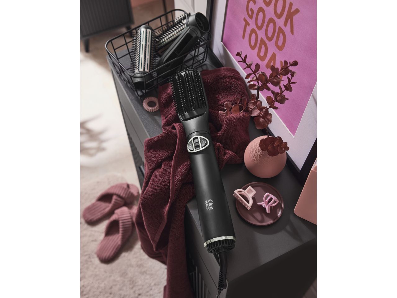 Cien Beauty hot air styler with various hair styling accessories and slippers on a dark surface.