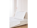 White pillow and duvet on a bed.