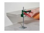 A hand operating a Parkside tile leveling system, supporting a floating shelf.