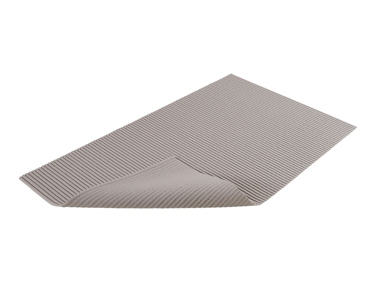 Grey ribbed bath mat with a curled edge
