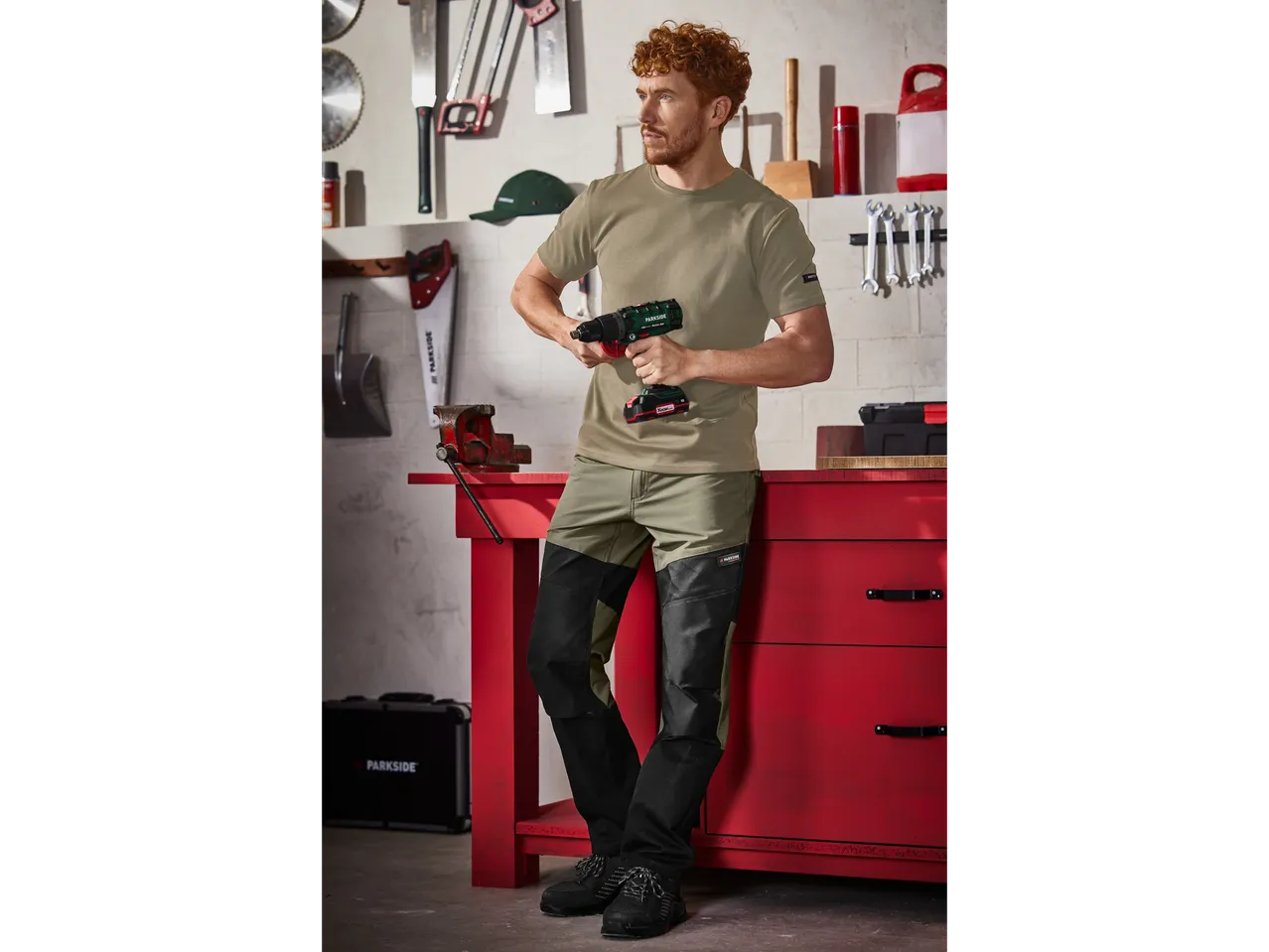 Man in Parkside workwear using a Parkside drill in a workshop.