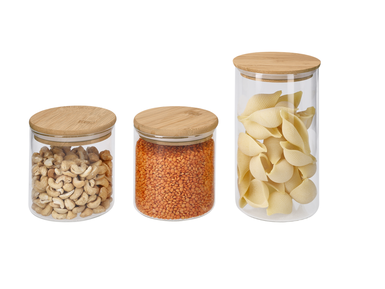 Trīs SILVERCREST® uzglabāšanas burkas ar koka vākiem, kas satur Indijas riekstus, sarkanās lēcas un makaronu čaulas.