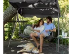Garden swing with canopy, couple relaxing.