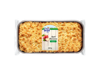 Apple crumble cake in a foil tray, with a label showing apples and text 