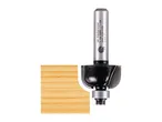 A router bit with a bearing, next to a piece of wood with a rounded edge.