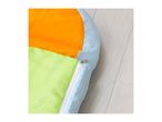 Colorful sleeping bag with orange, lime green, and light blue sections, featuring a white zipper.