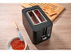 A black 2-slice toaster with glowing elements, toast, jam, and a knife on a wooden table.
