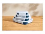 Stack of four rectangular collapsible food containers with clear lids on a wooden surface.