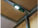 PARKSIDE® Rechargeable Light illuminating a construction framework with wooden panels.