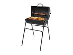 Black charcoal barbecue grill with various meats and vegetables cooking on it.