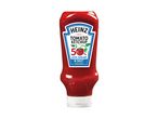Tomato ketchup bottle with a label indicating 50% less sugar and salt.