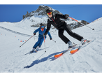 Two skiers wearing Esmara® ski goggles and ski equipment on a snowy slope.