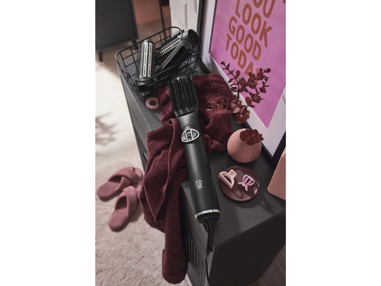 Cien BEAUTY Rotating Hot Air Styling Brush with accessories and slippers on a dark surface.