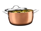Copper-colored cooking pot filled with vegetables and a partially open lid