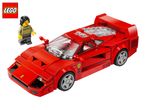 Red toy sports car with a minifigure wearing a sweater with text, on a white background.