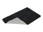 Black bath mat with a non-slip backing, partially folded to show the underside.