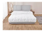 A modern bedroom with a grey upholstered bed, white duvet, and wooden nightstands.