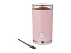 Pink electric coffee grinder with ground coffee inside and a cleaning brush next to it.