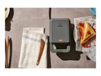 SilverCrest sandwich maker with cooked sandwiches and a towel on a table.