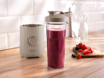 SILVERCREST® To Go Smoothie Maker with a berry smoothie and fresh fruit on a wooden counter.