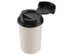 A light-colored travel mug with a black flip-top lid, viewed from above.
