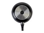 Bottom view of a black frying pan with a textured silver base and a black handle.