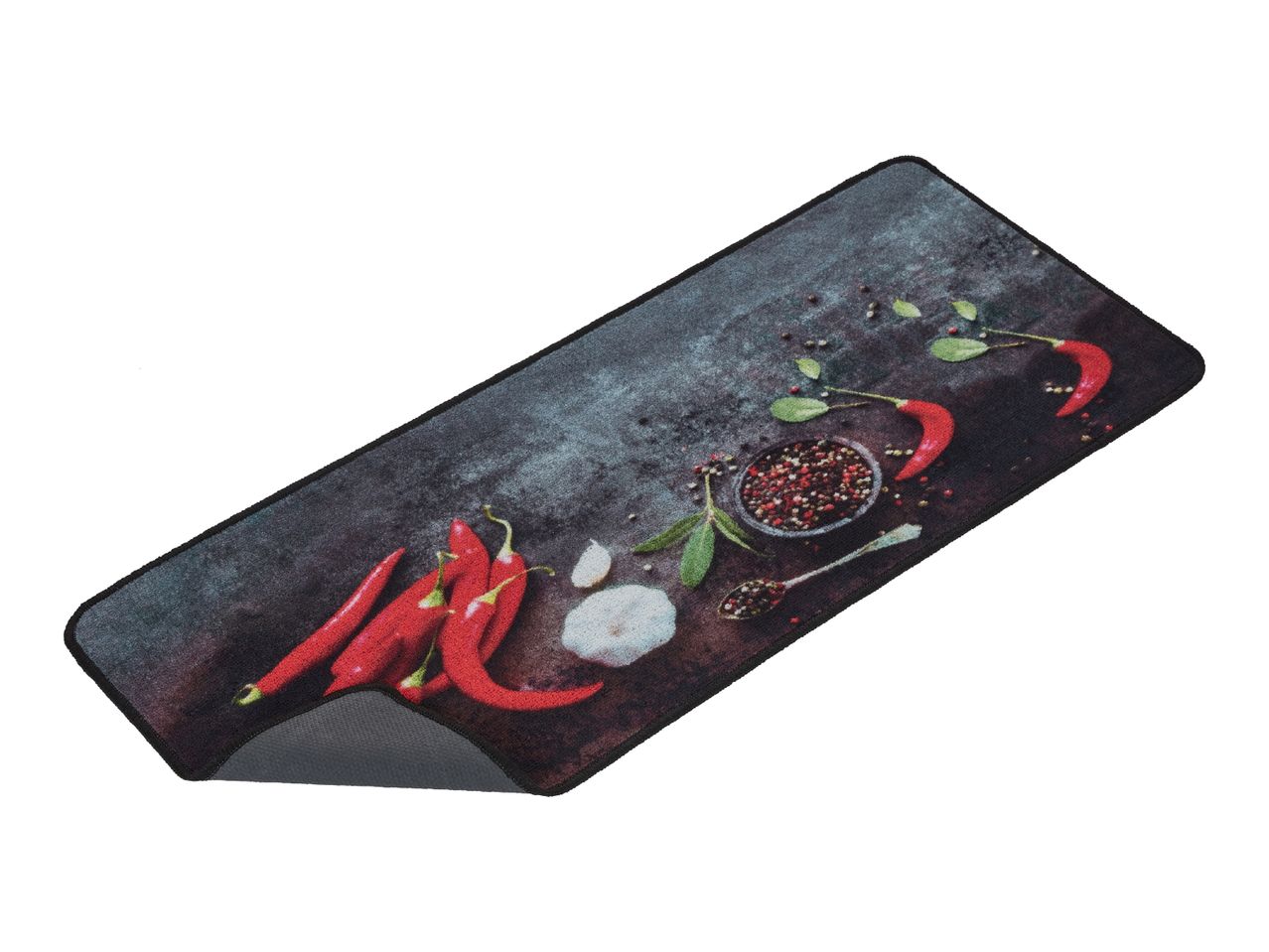 A rectangular black placemat features a vibrant chili pepper and spice design.