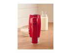 Red hand mixer standing on a wooden countertop next to a bowl of flour and a bottle of milk.
