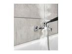 Steam cleaner nozzle cleaning a chrome shower mixer tap and tiled wall in a bathroom.