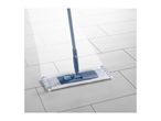 A blue flat mop with a white and blue microfiber pad on a light gray tiled floor.