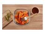 Marinating chicken wings with barbecue sauce and rosemary on a wooden board.