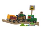 Wooden toy train with a dinosaur theme, featuring a safari-clad figure and a dinosaur crossing sign.
