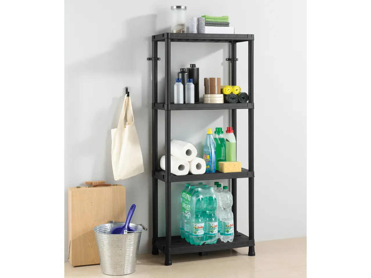 Black plastic shelving unit holding cleaning supplies and other household items.