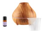 Wooden essential oil diffuser with a bottle of oil and measuring cup.
