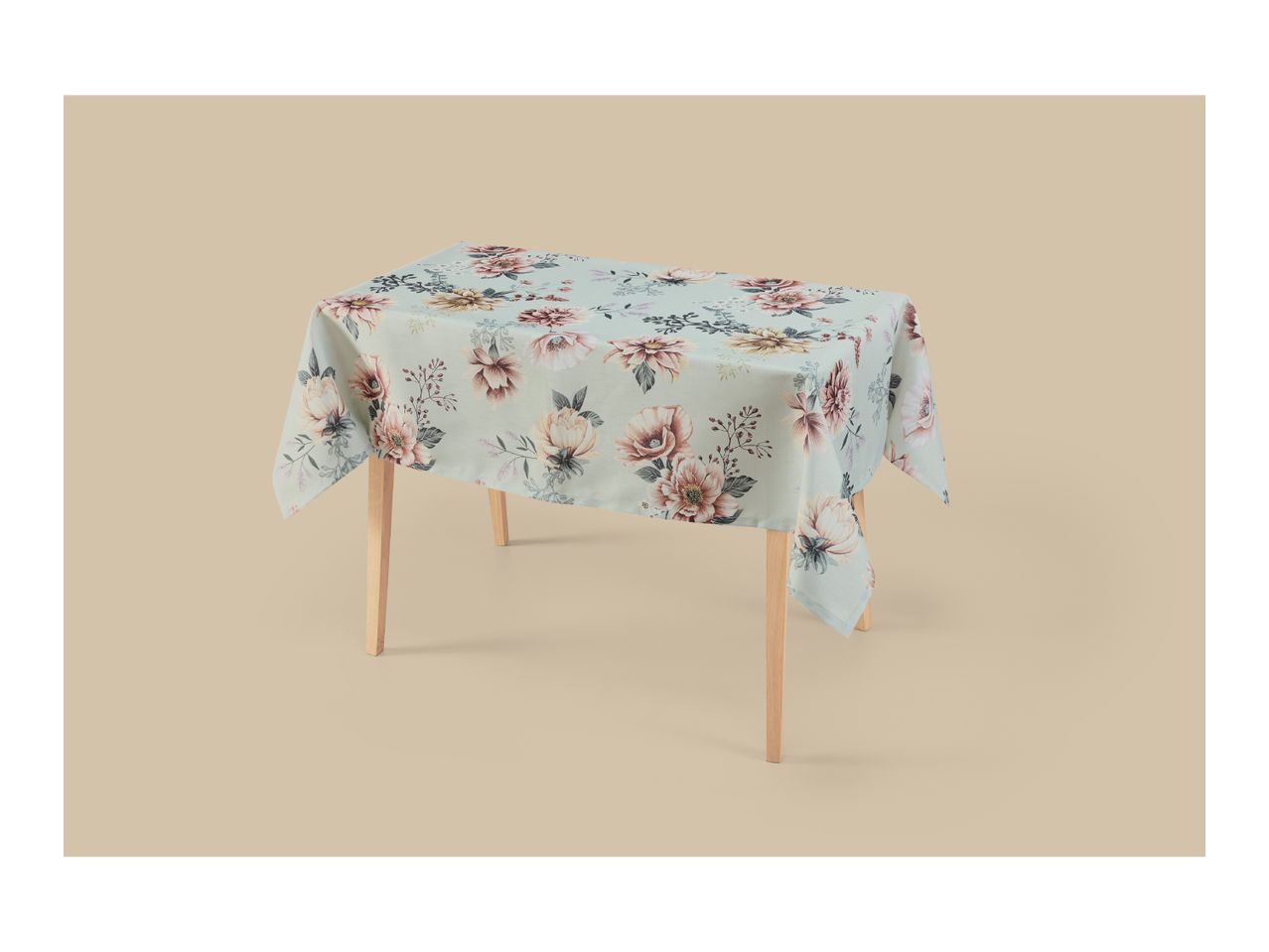 Light blue floral tablecloth on a wooden table.