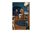 A child's bedroom with space-themed bedding, a rocket lamp, and a glow-in-the-dark rug.