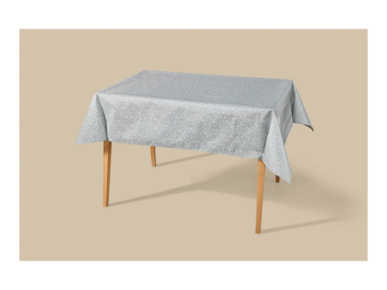 Table with a light blue tablecloth featuring a subtle leaf pattern.
