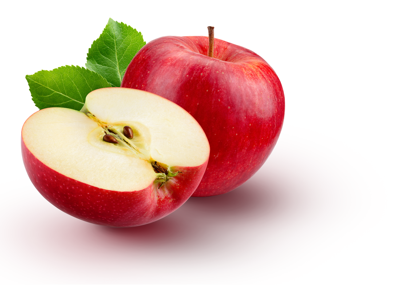 A whole red apple and a half-cut red apple with green leaves.