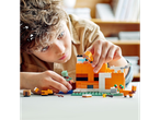 A child builds a LEGO Minecraft set featuring a creeper and fox.