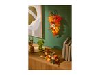 Autumnal home decor with a lit-up leaf garland, mushroom lamp, and candle arrangement.