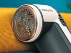 Philips fabric shaver on a yellow textile surface.